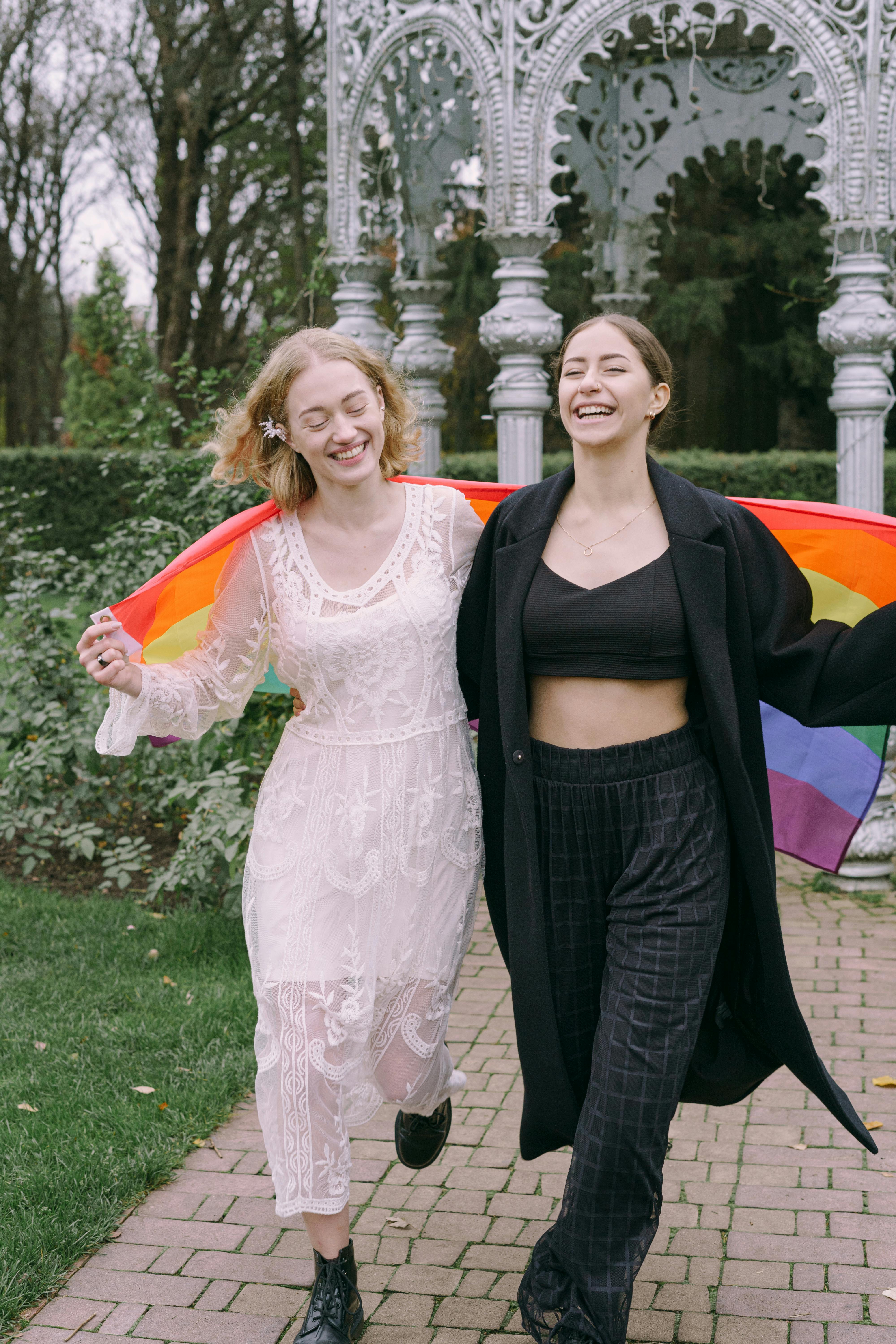 couple walking together with gay pride flag