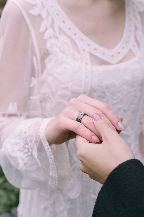 Free Hand of Woman Holding Hand of Woman with Black Ring Stock Photo