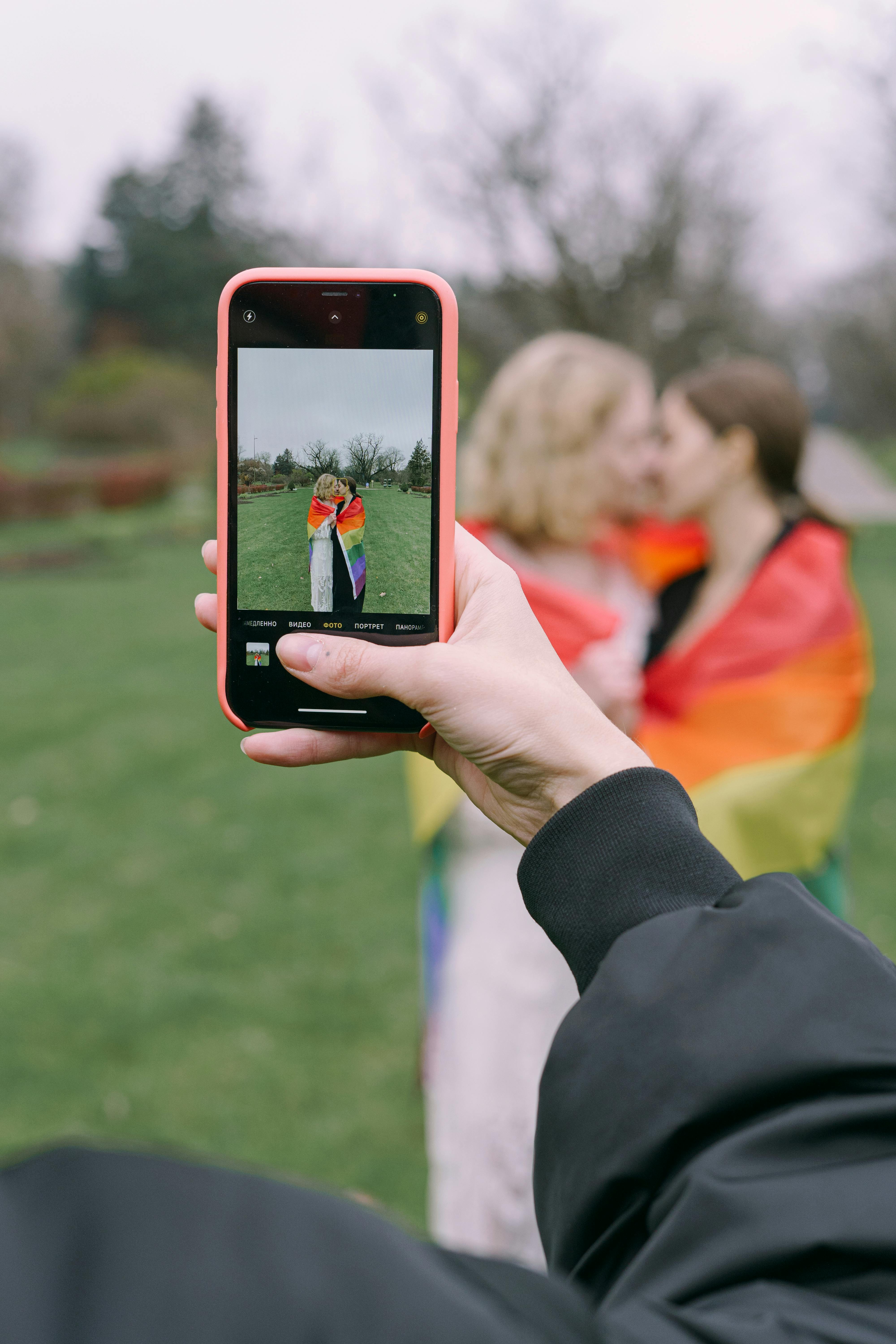 Women Sitting on a Couch with LGBT Flag · Free Stock Photo