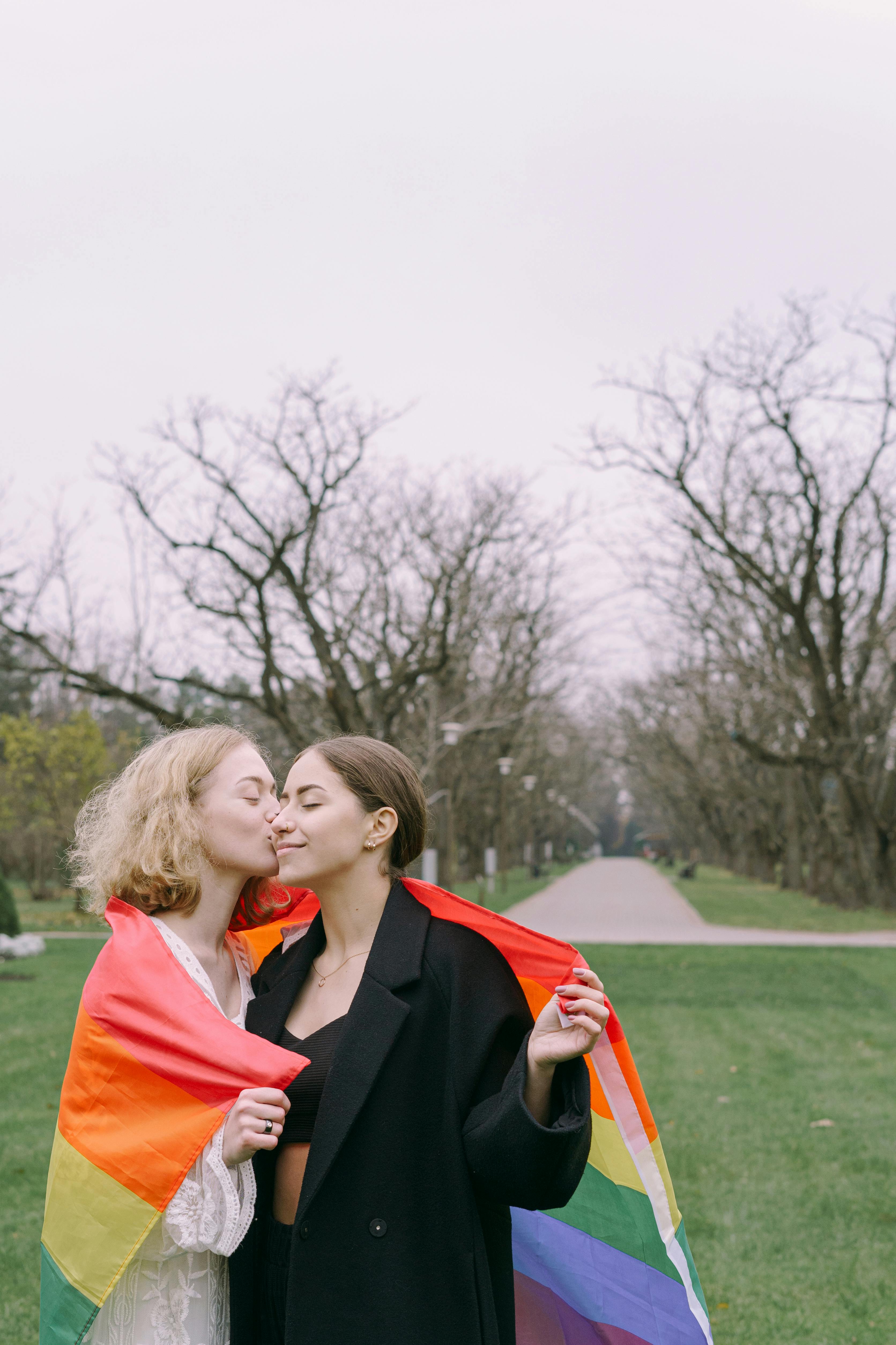 a woman kissing another woman