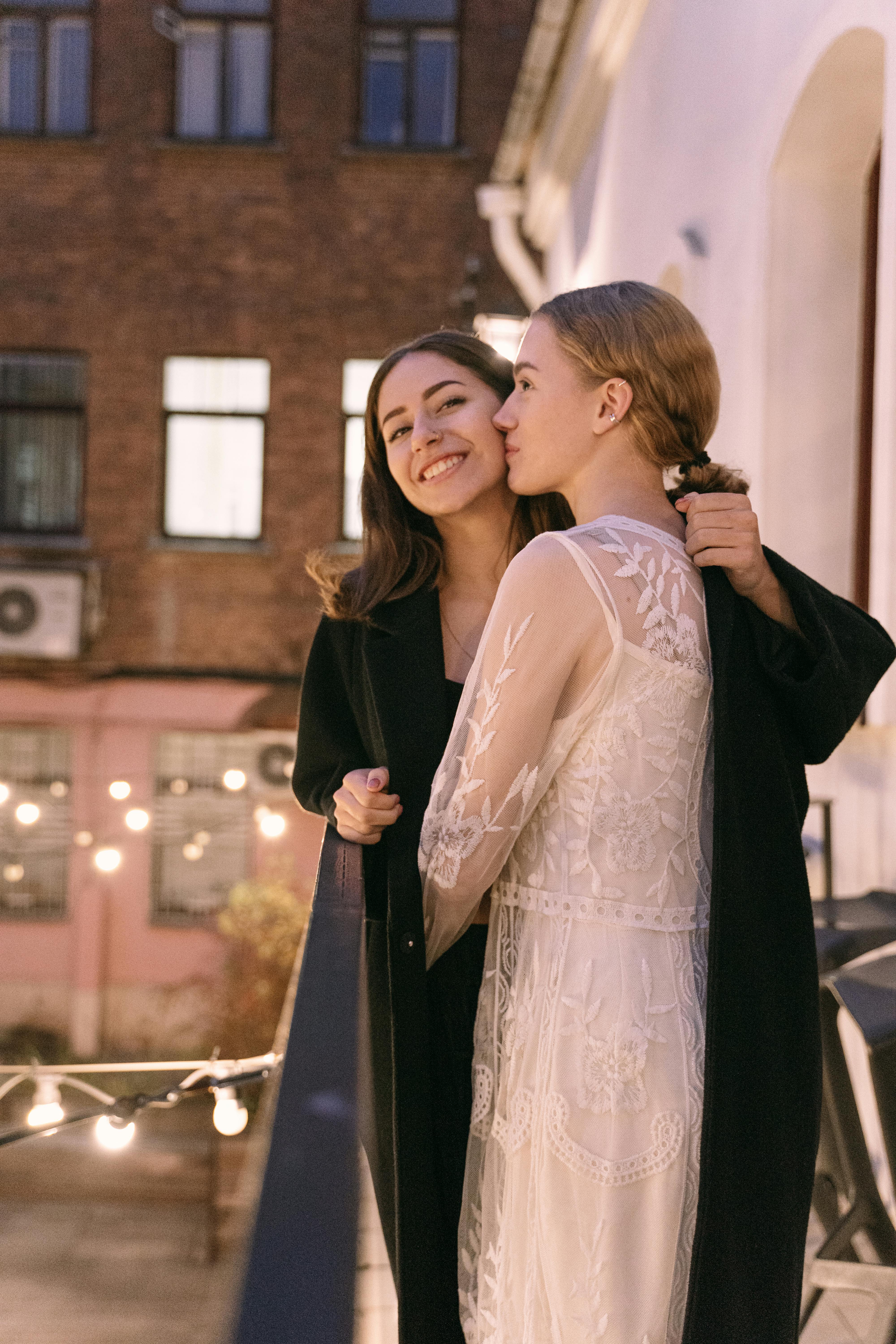 a same sex couple standing together at the balcony