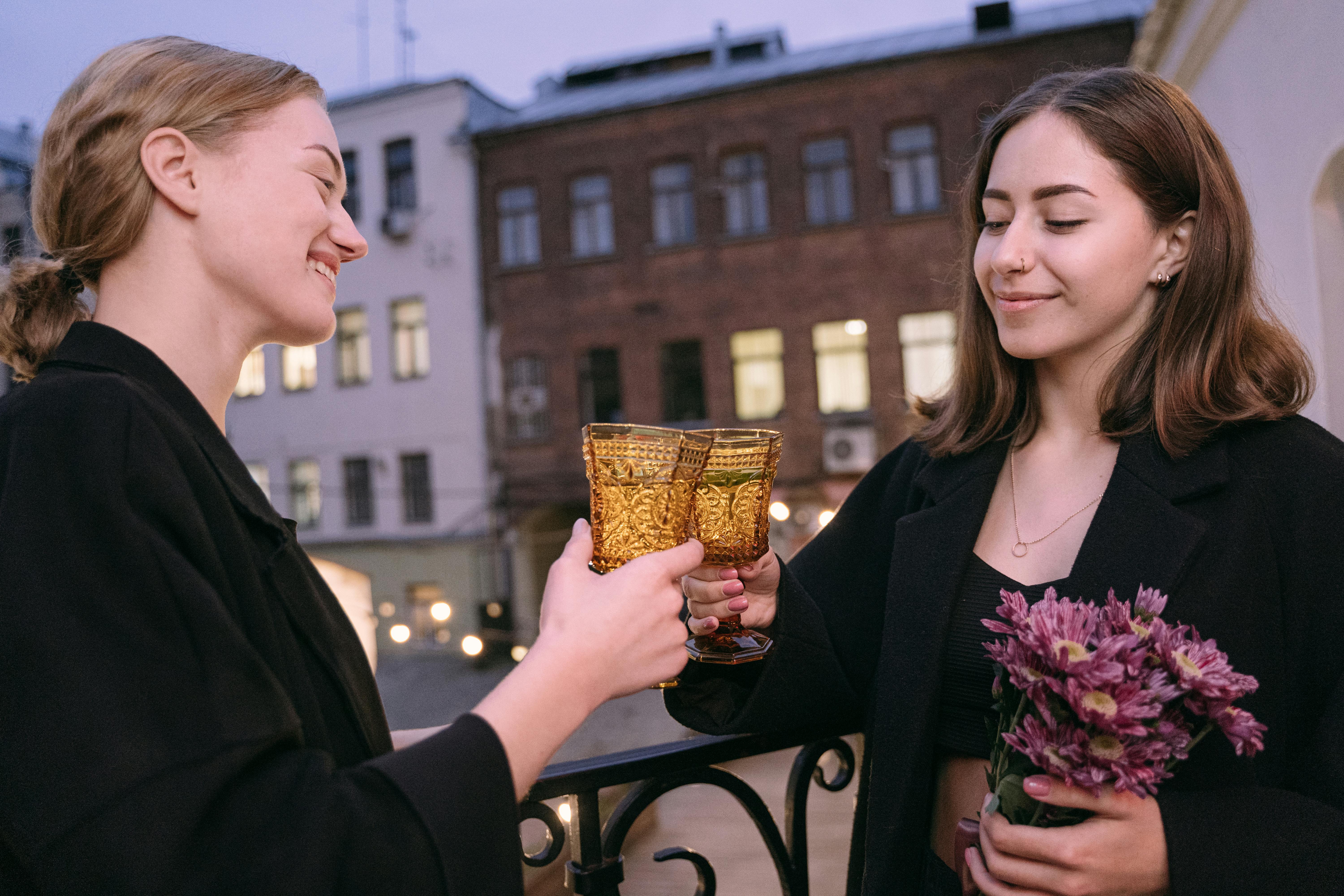 a couple toasting drinks