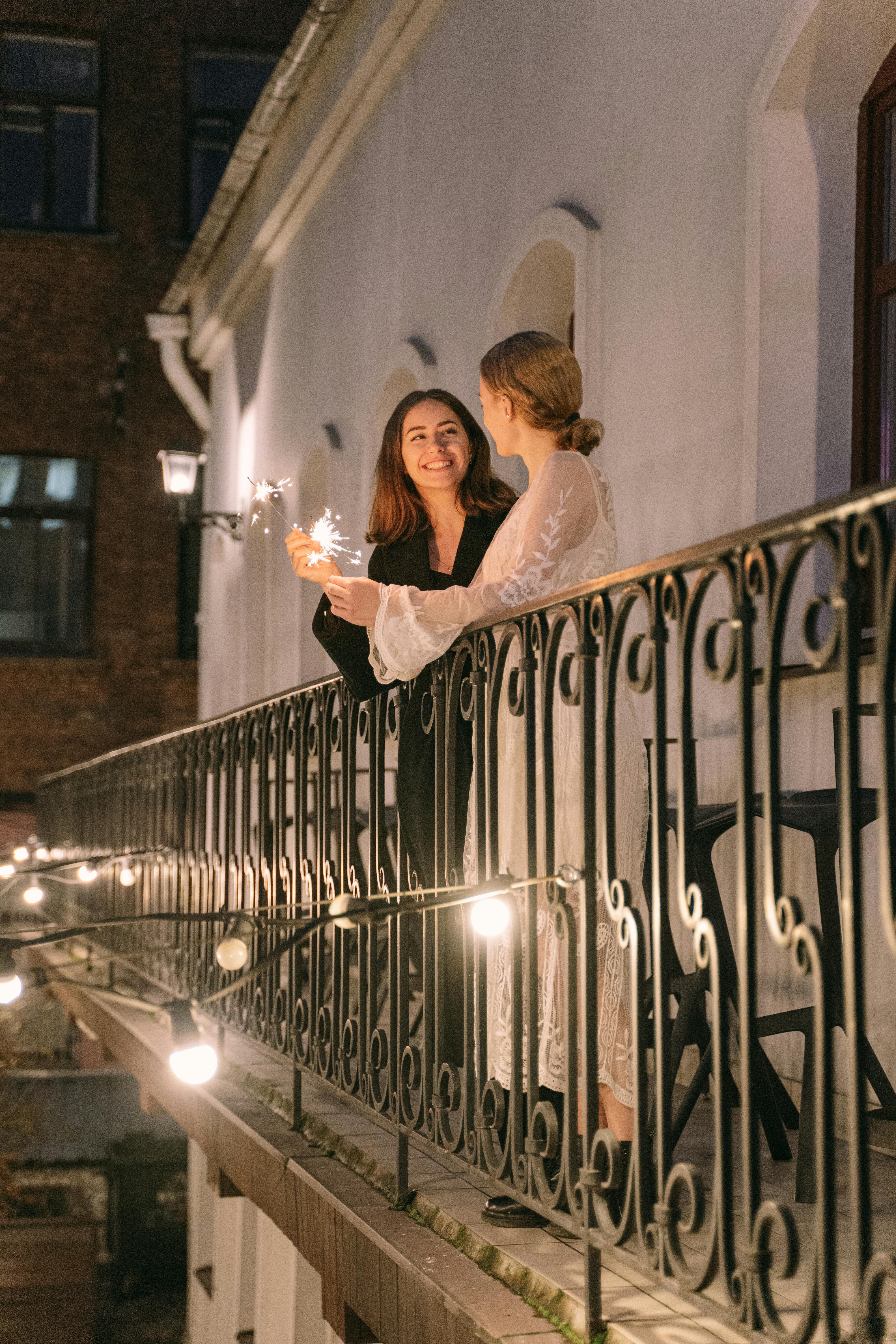 woman in white wedding gown holding lighted candles