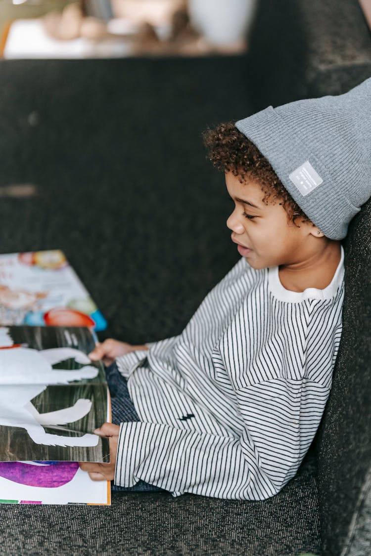 Cute Black Boy Reading Fairytale In Book