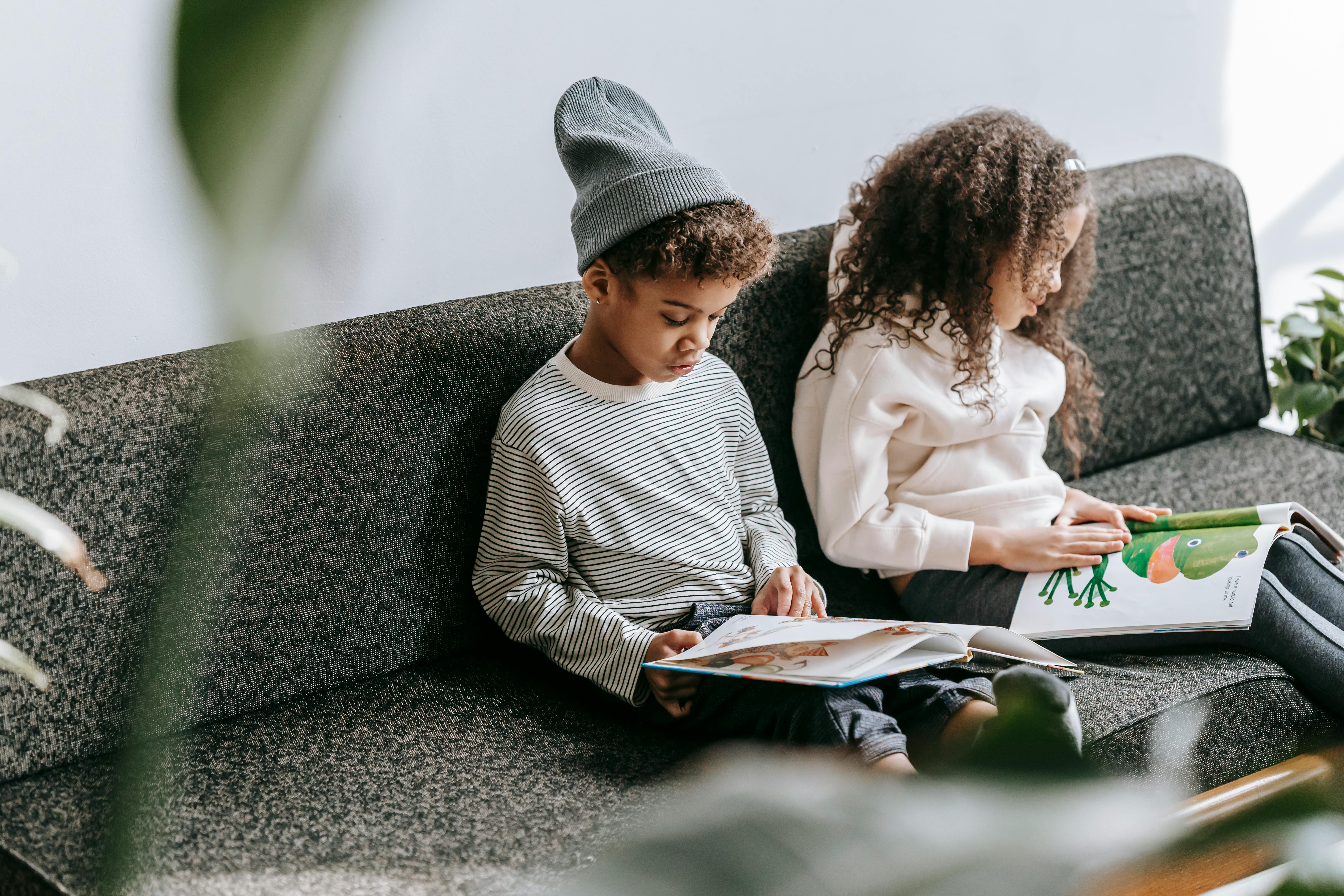 focused black children reading books with bright illustrations