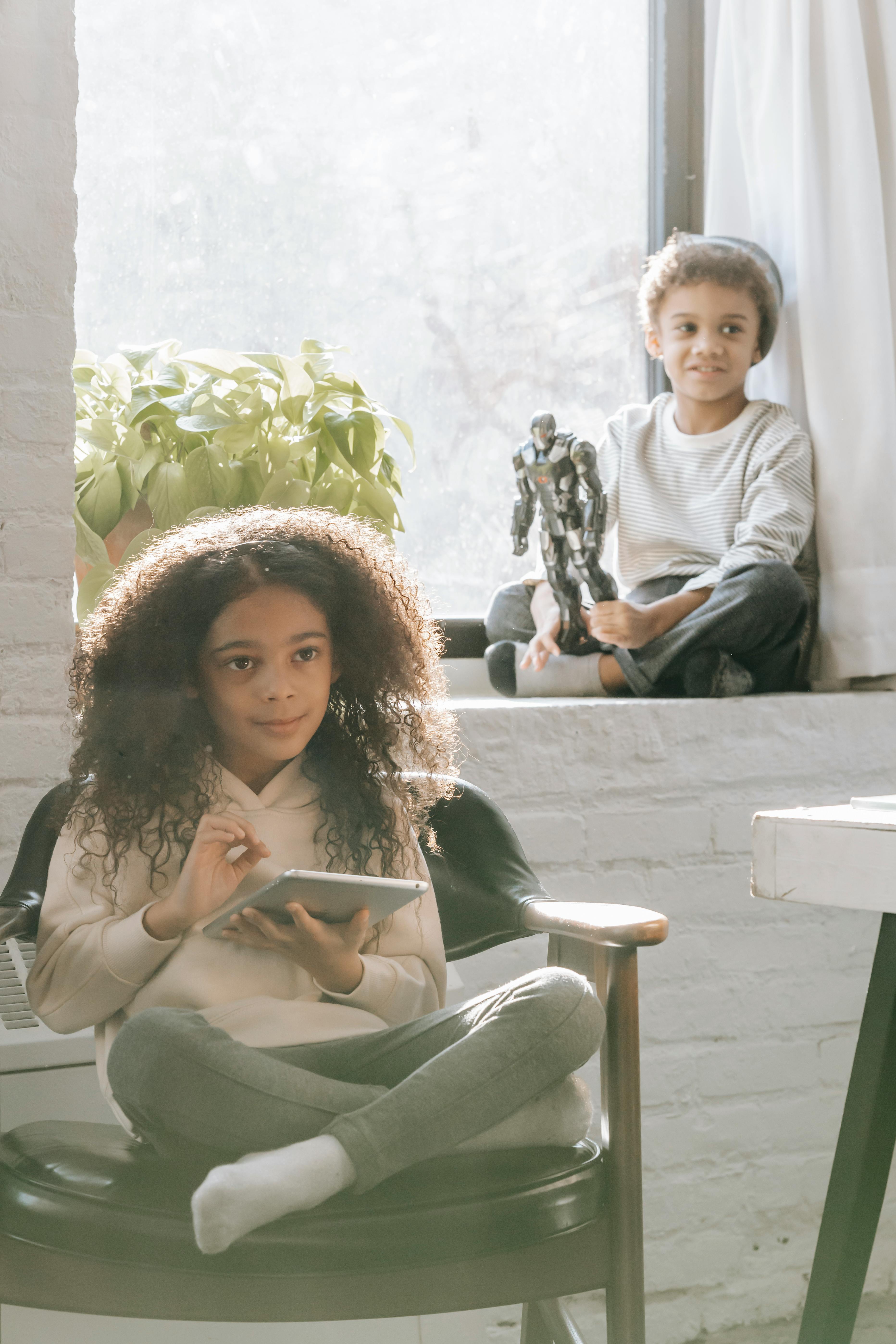 cheerful black children spending time at home in daytime