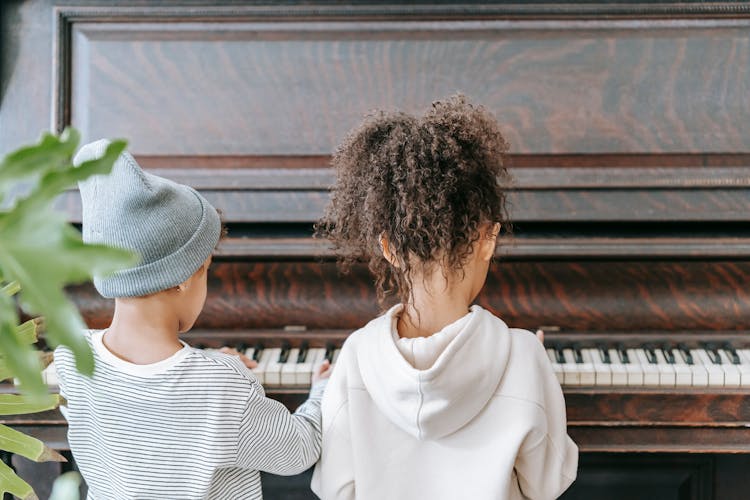 Anonymous Ethnic Kids Playing On Piano In Room