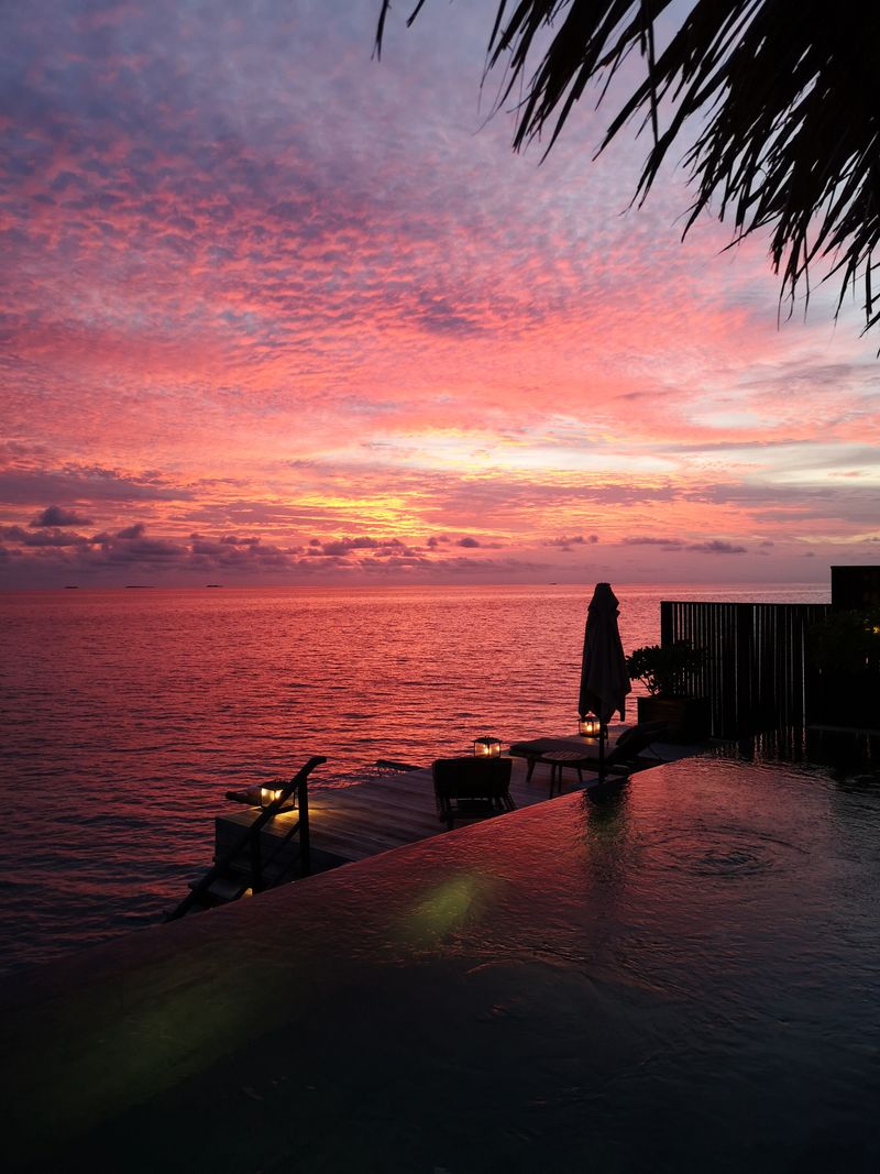 Infinity pool at seaside resort at sunset Mediterranean sea