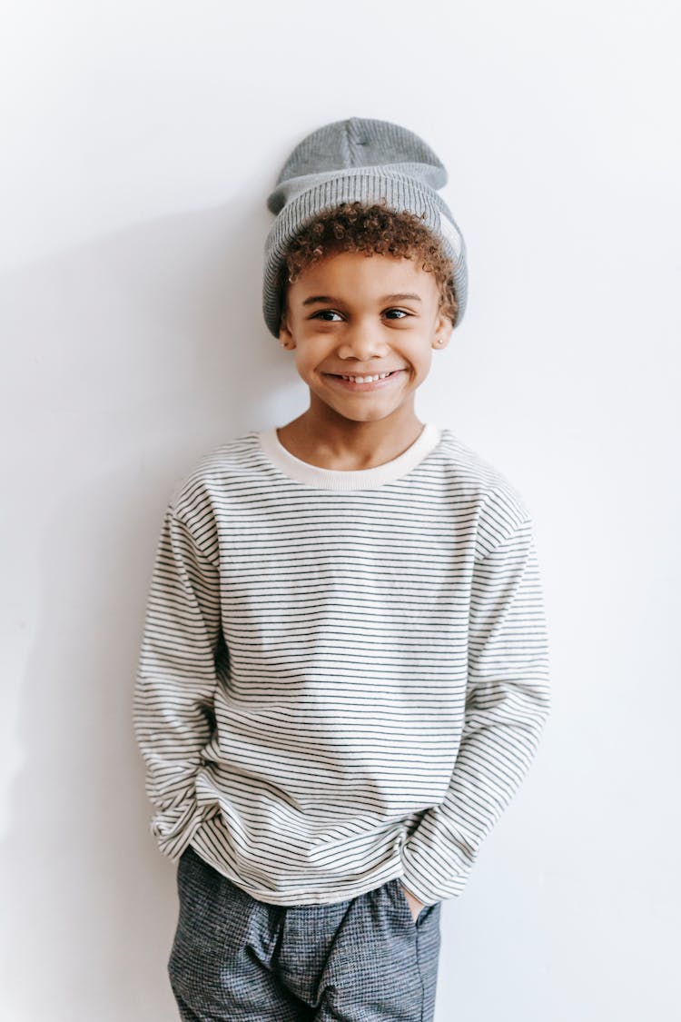 Cute Black Boy Standing Near Wall