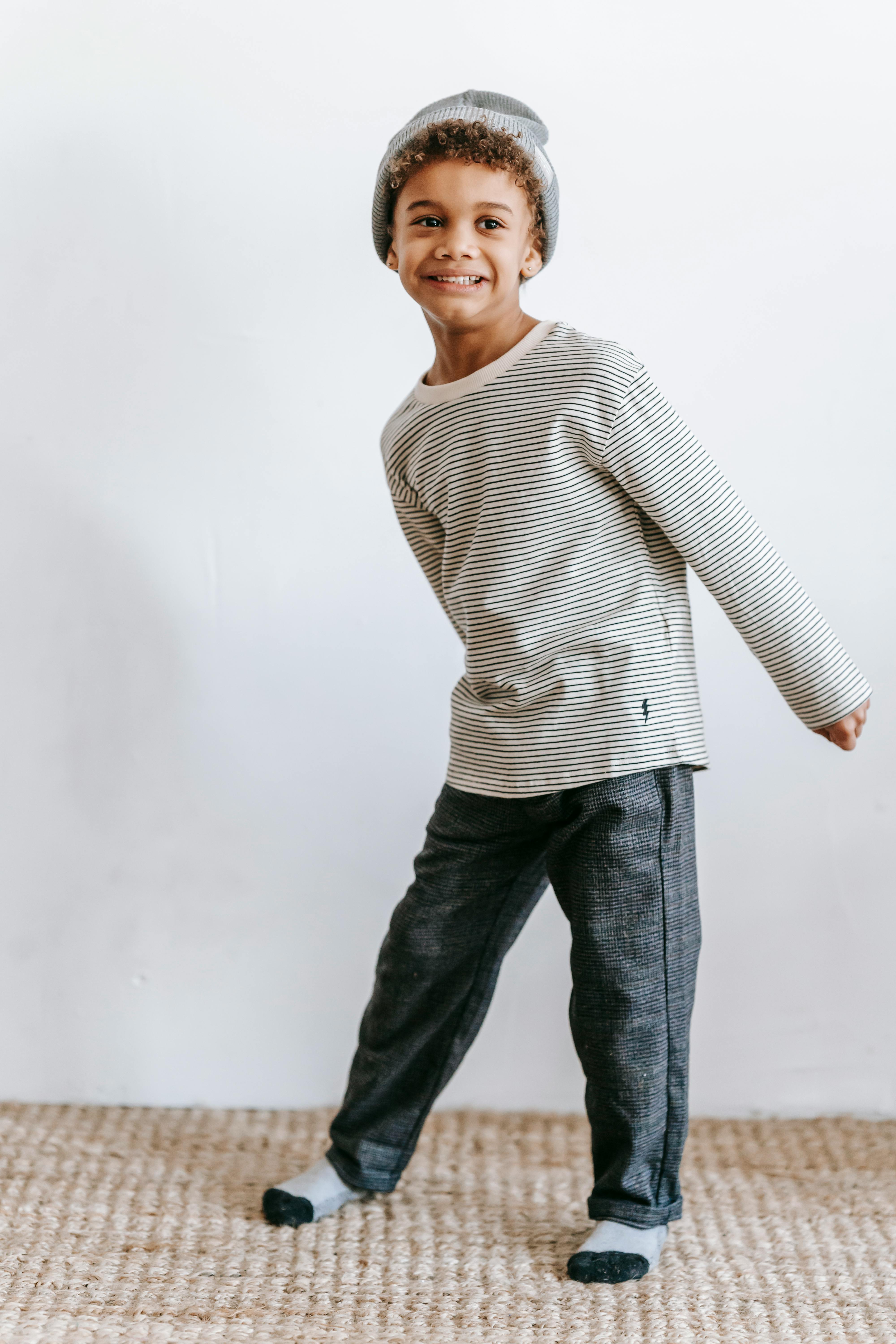 stylish black boy dancing in room