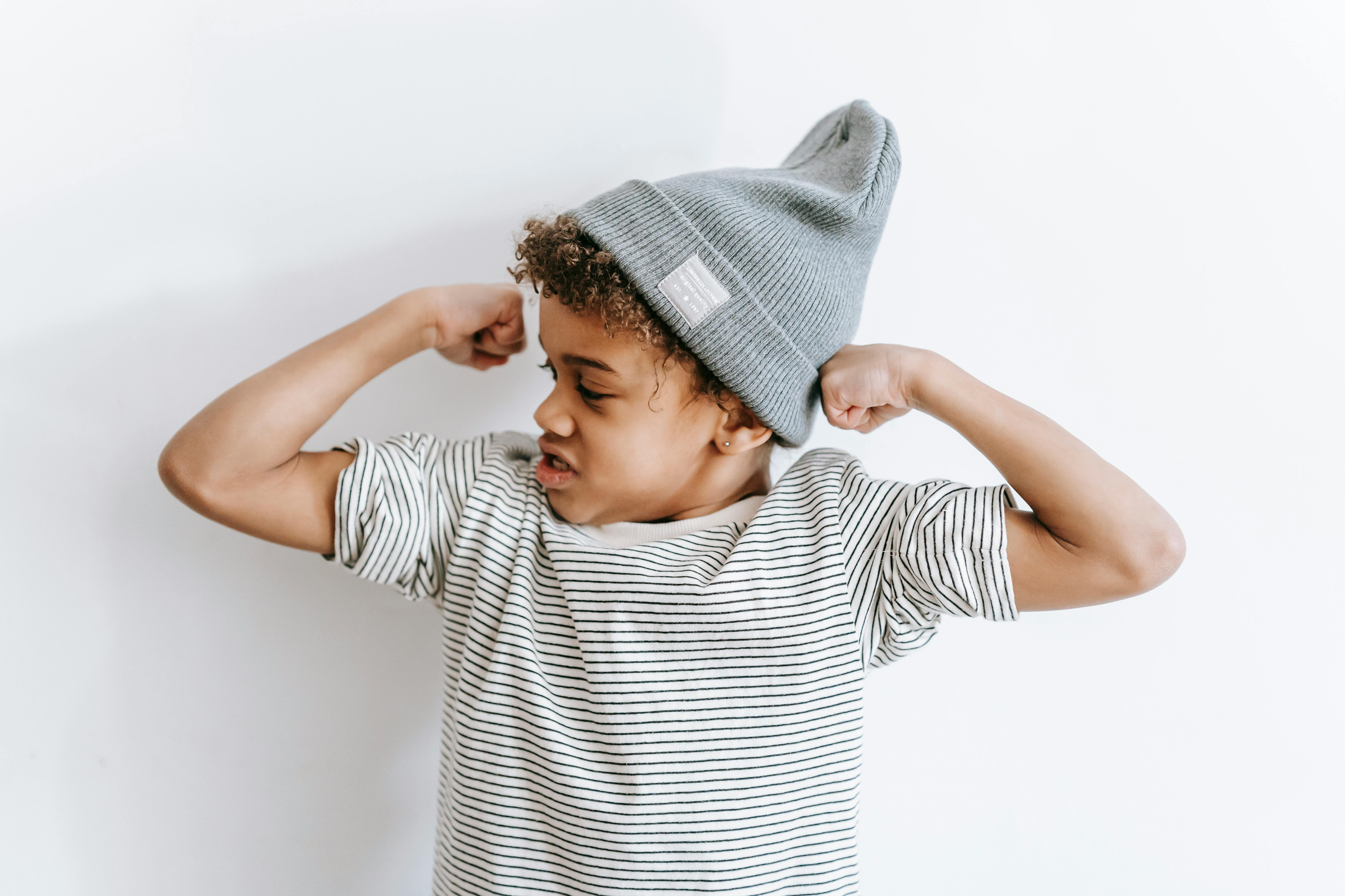 black boy demonstrating strength near wall