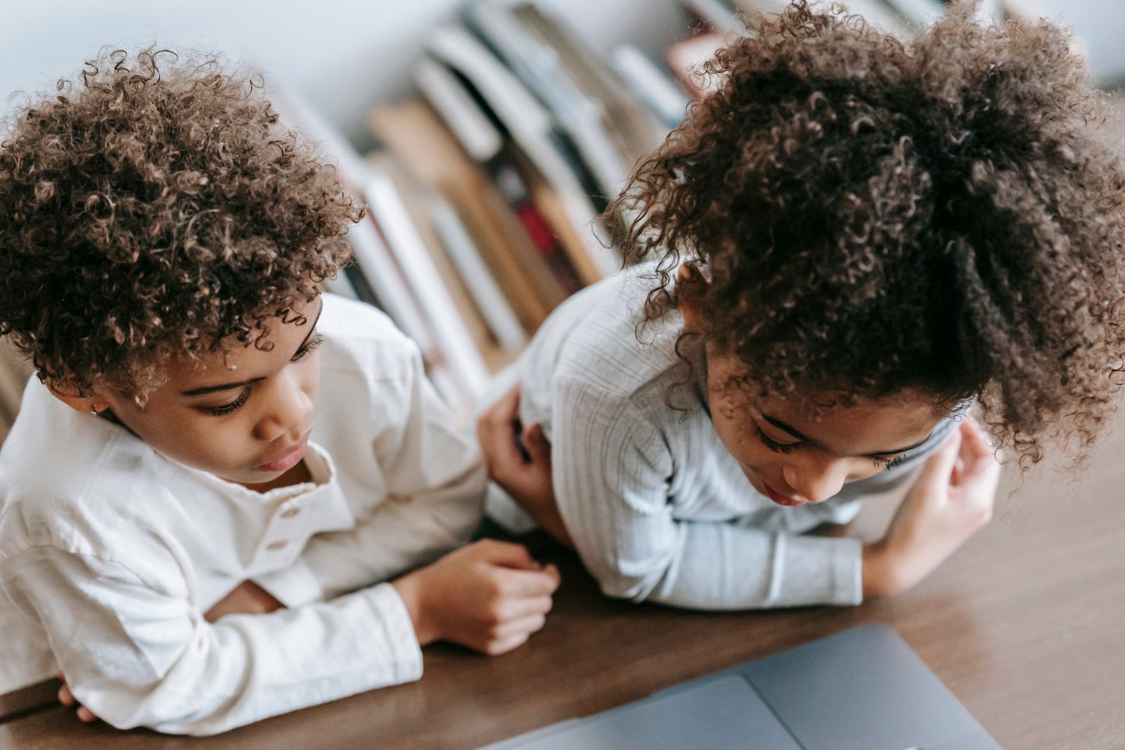 Illustrative stock photo of two children exploring a laptop together