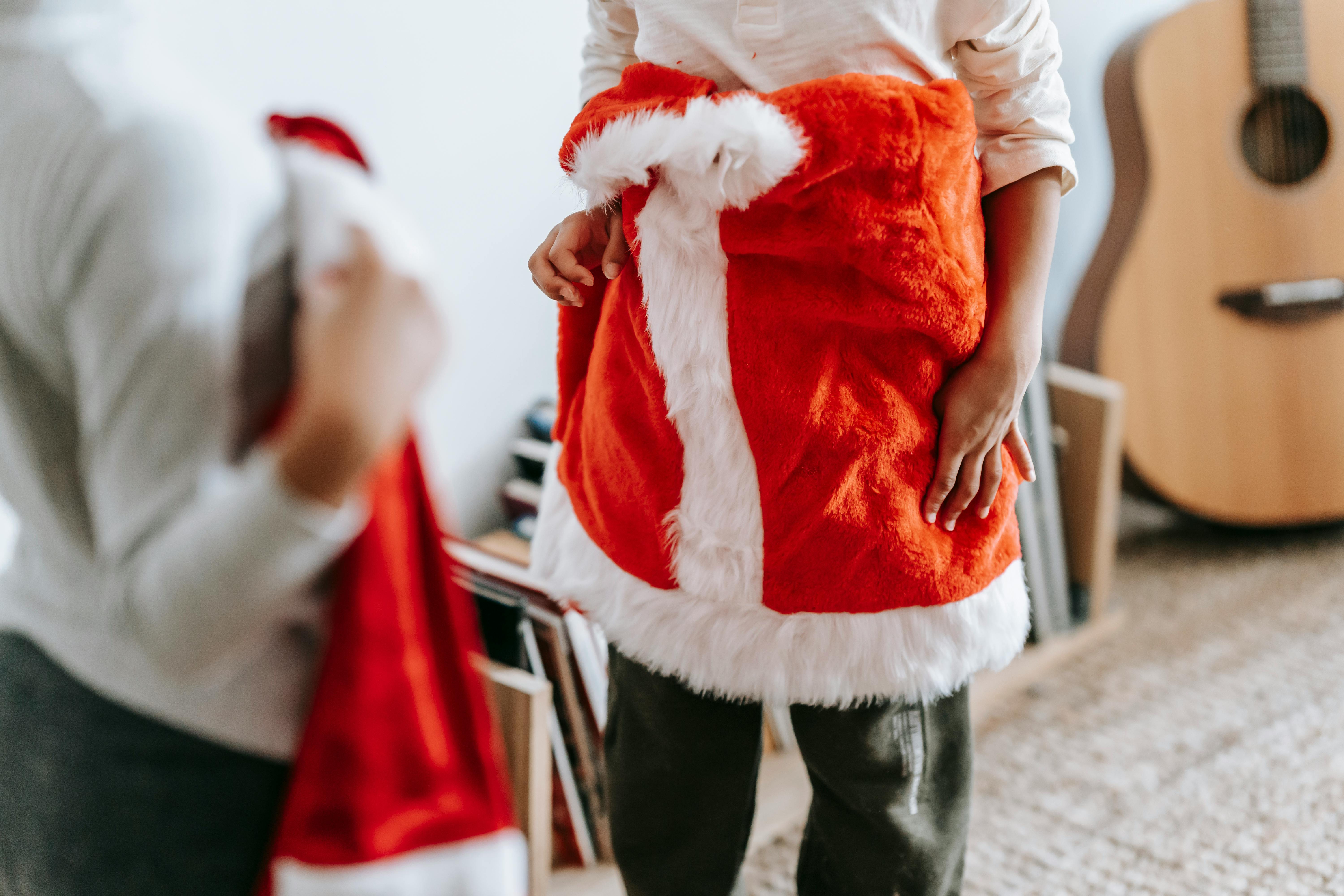 crop children with santa claus costumes