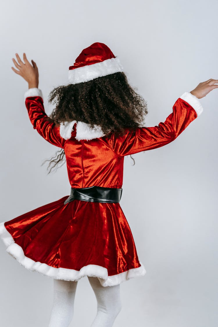 Unrecognizable Black Girl In Santa Dress Having Fun