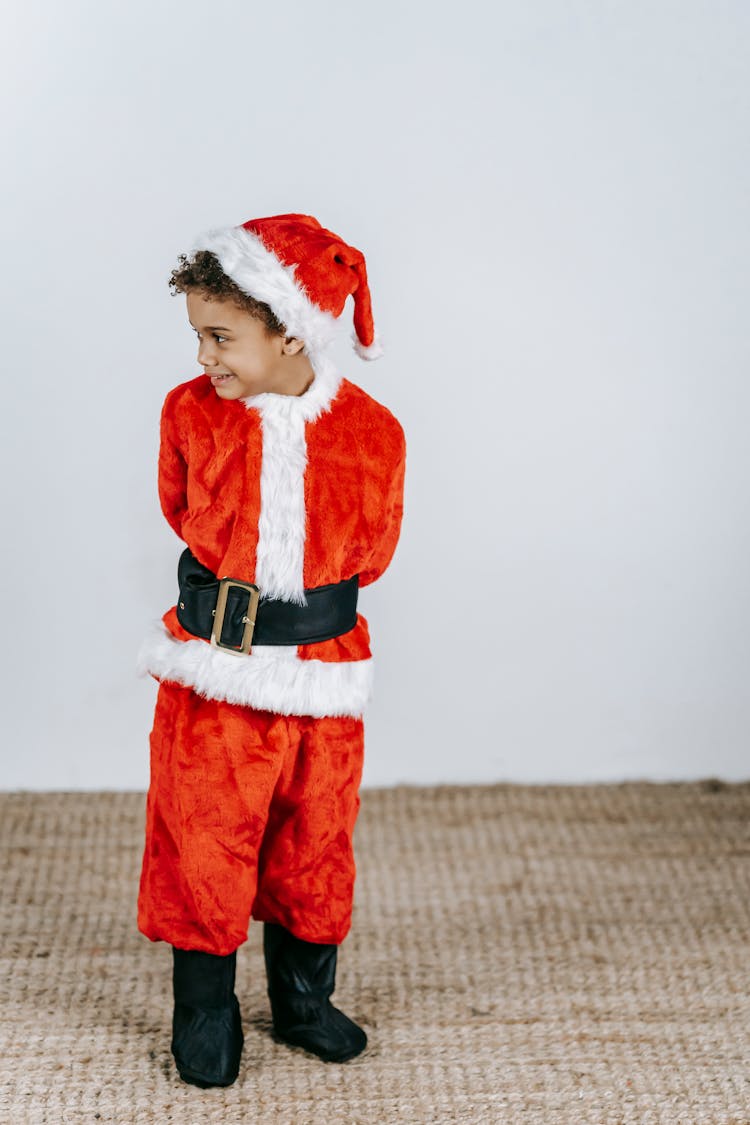 Black Boy In Santa Costume On Christmas Day