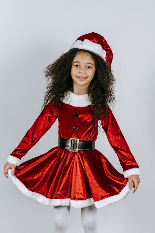 Charming black girl in Santa costume on Christmas day