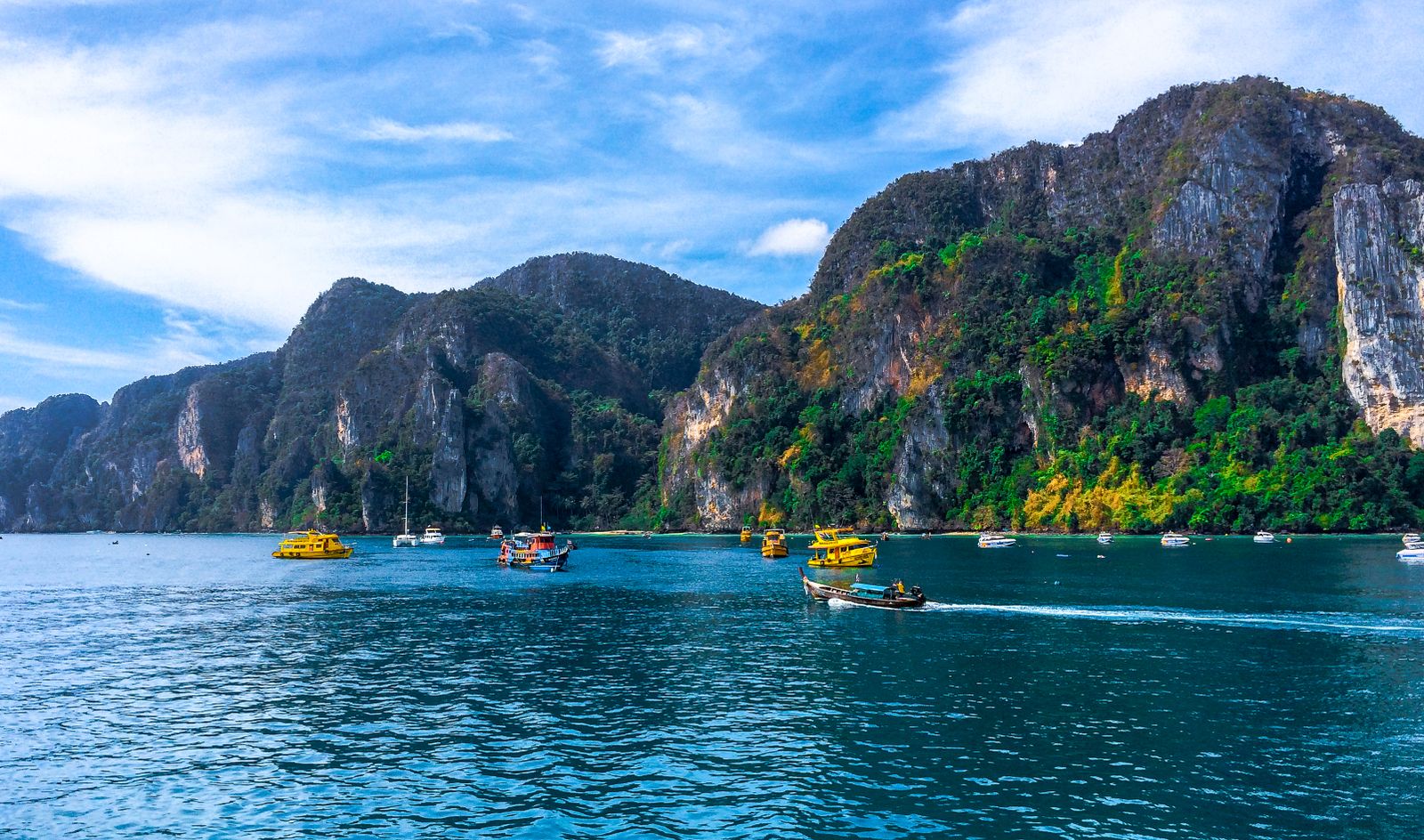 Phi Phi Island bay with boats and limestone mountains