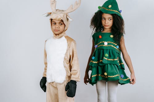 Free Cute black children wearing festive costumes in light studio Stock Photo