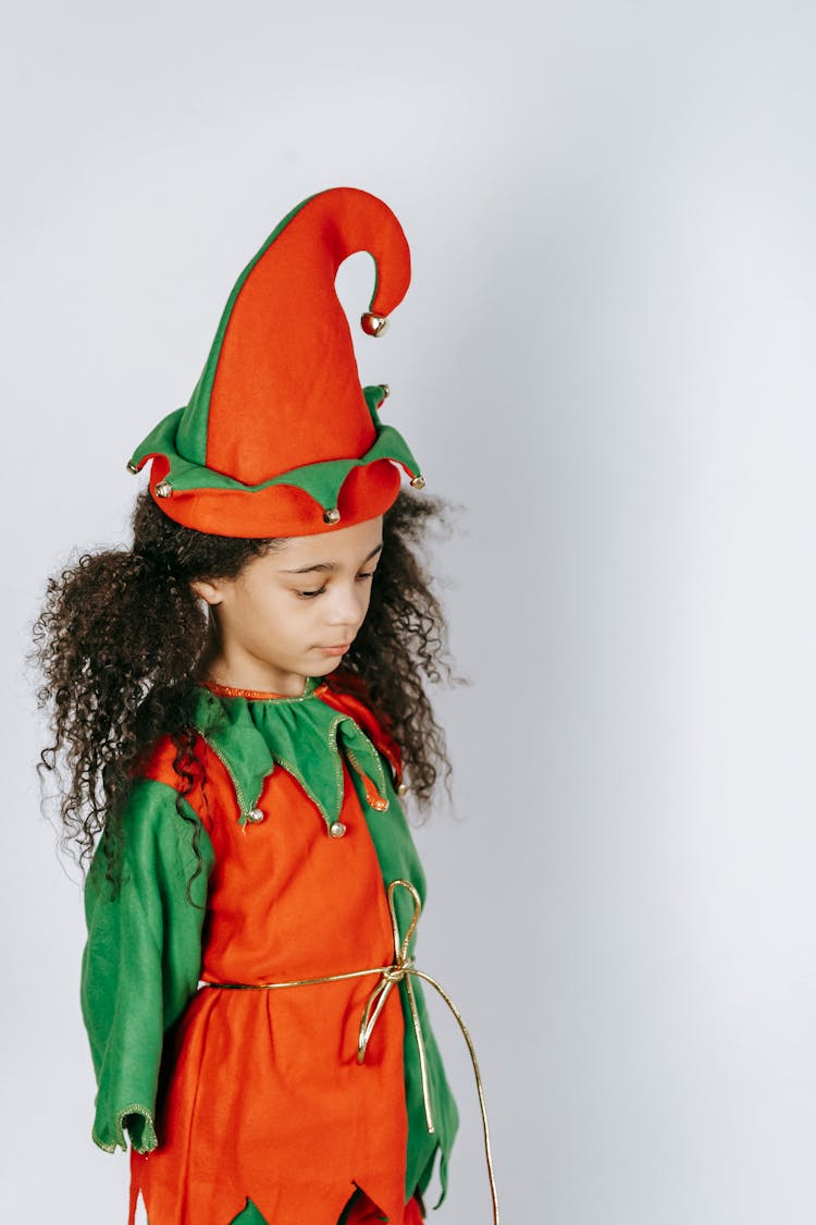 Sad Black Girl In Elf Costume Near Wall