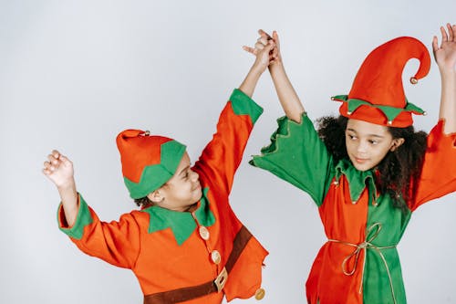 Free Cute black children in elf outfits on white background Stock Photo