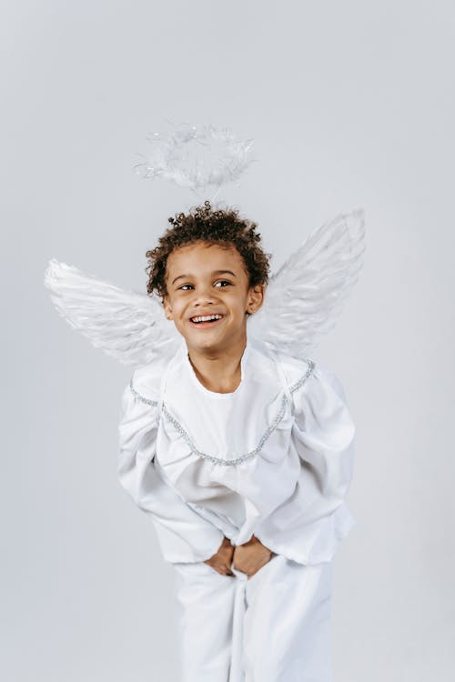 Cheerful black boy in angel costume during Christmas celebration · Free  Stock Photo