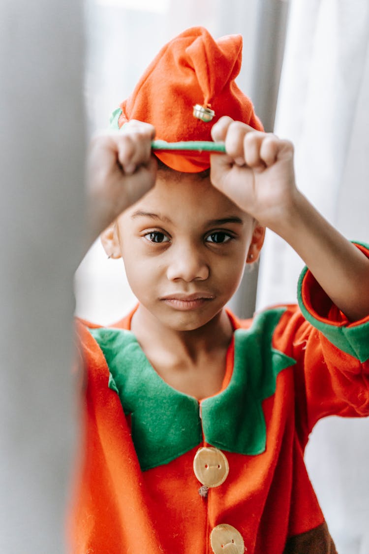 Content Black Boy In Elf Costume Near Window