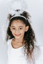 Cute black girl in costume of angel with soft nimbus