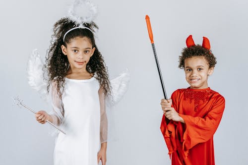 Black children in costumes of angel and devil