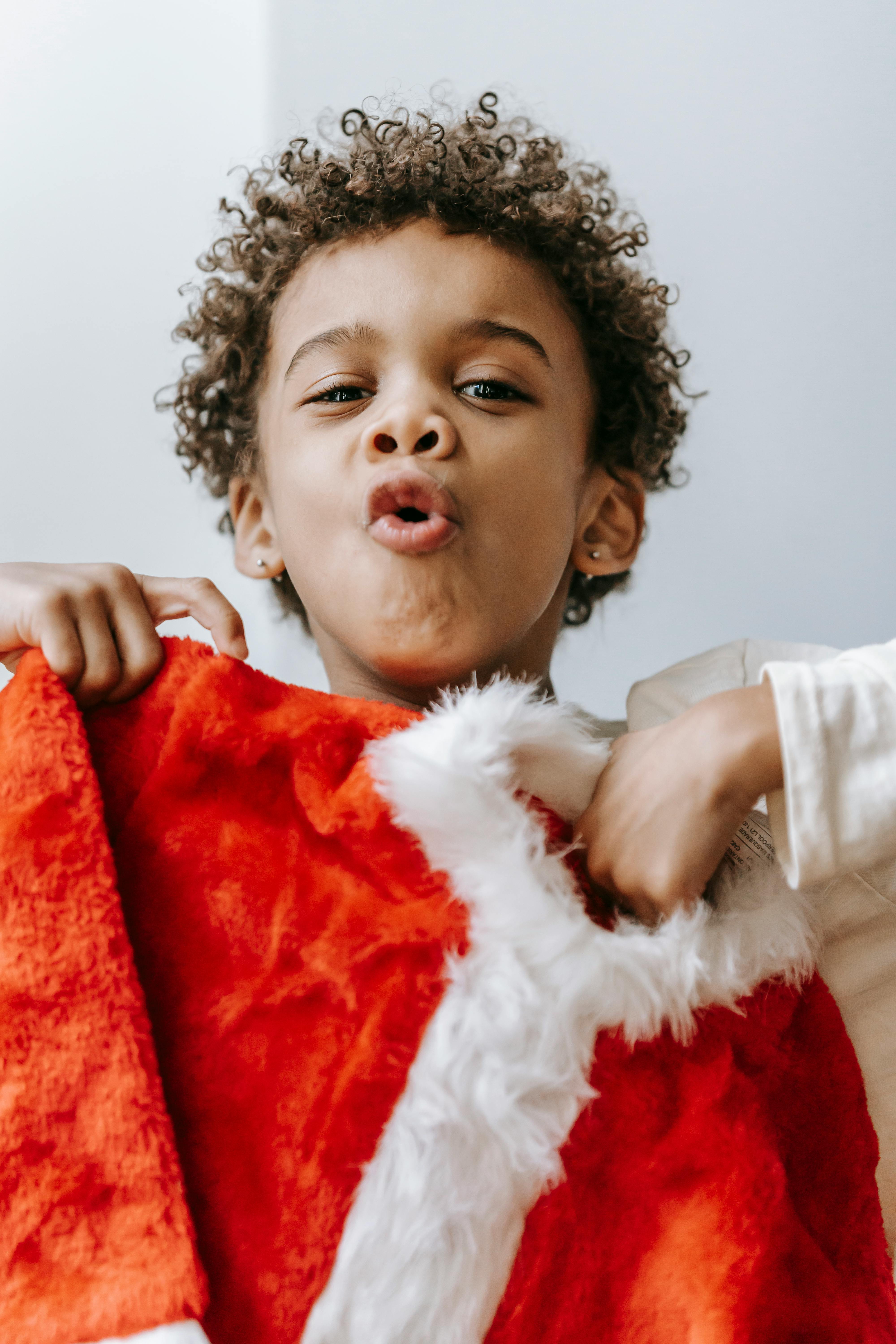 positive black boy showing christmas outfit