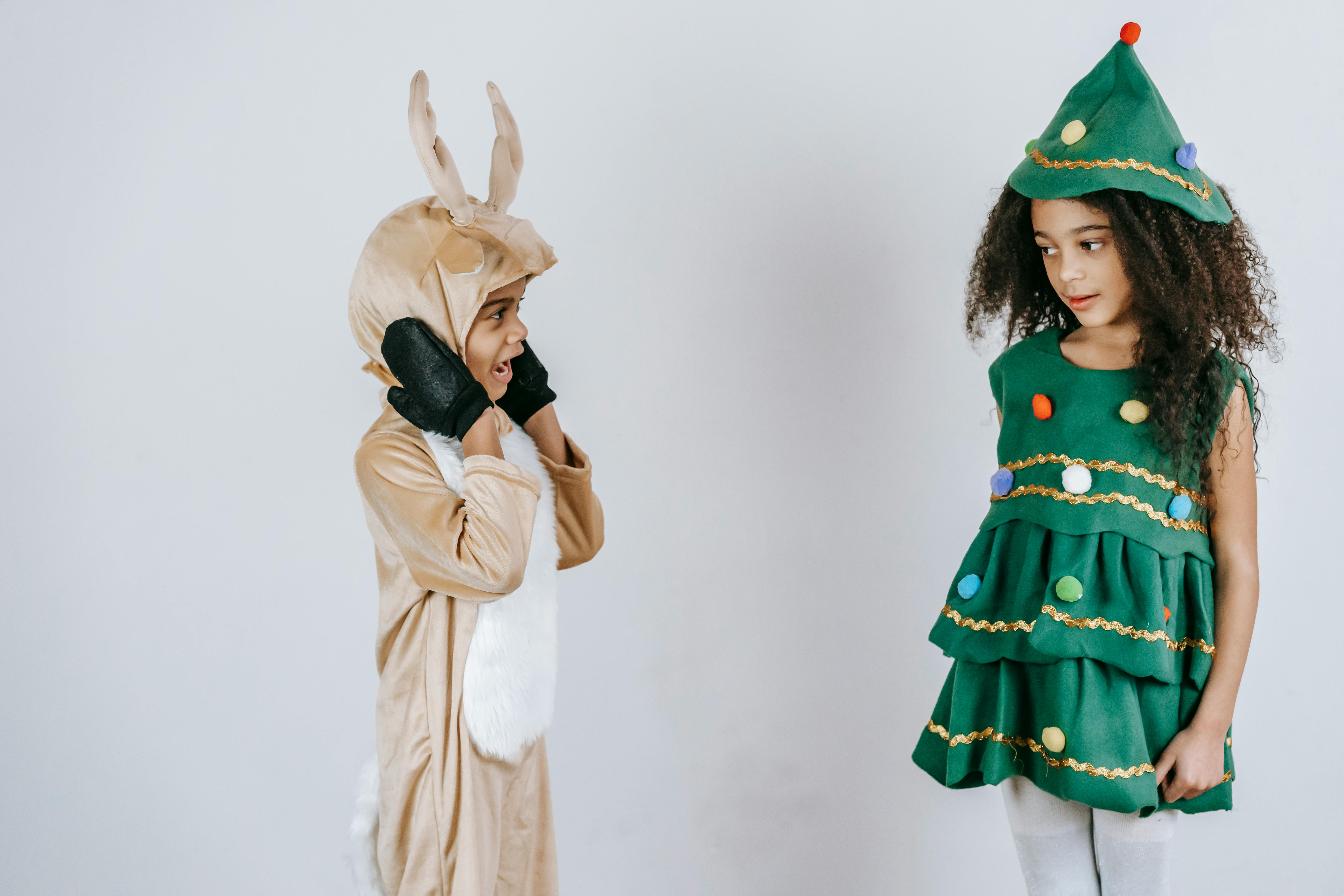 black children in costumes of christmas tree and reindeer