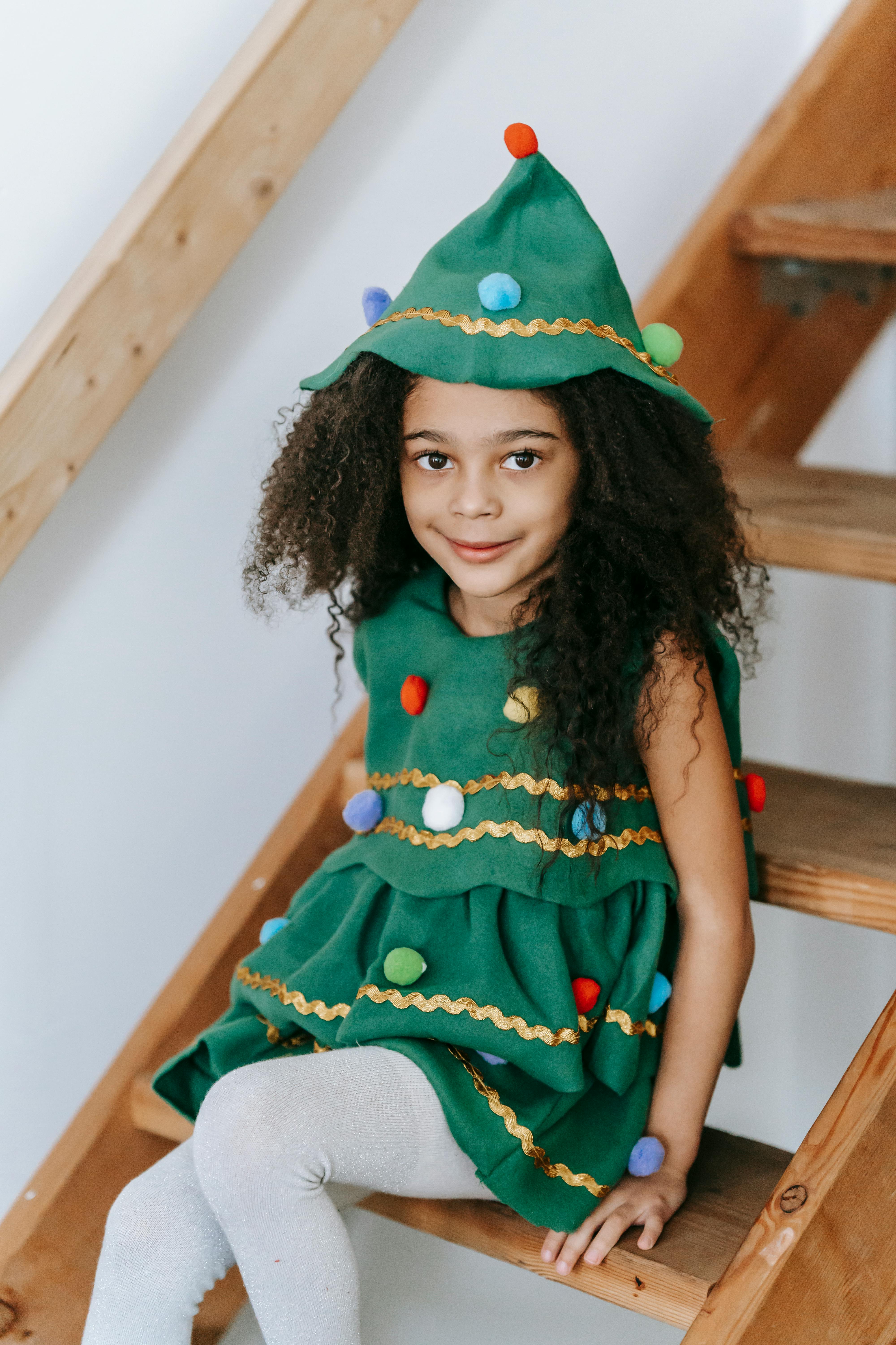 cute black girl in costume of christmas tree