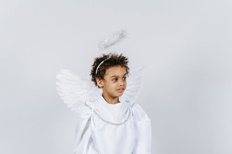 Funny Adorable Little Black Boy In White Costume Of Angel