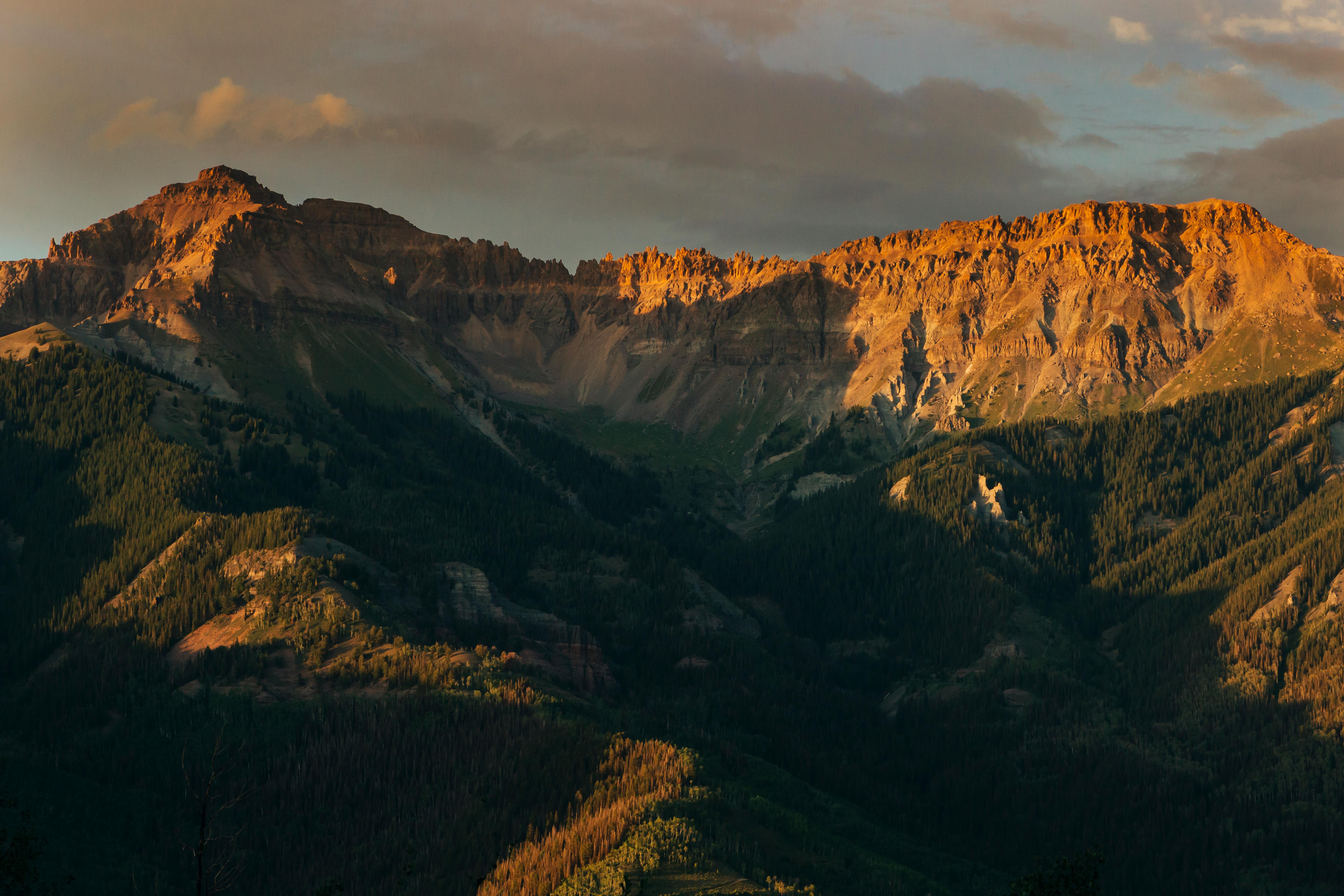 green and brown mountains under the sky