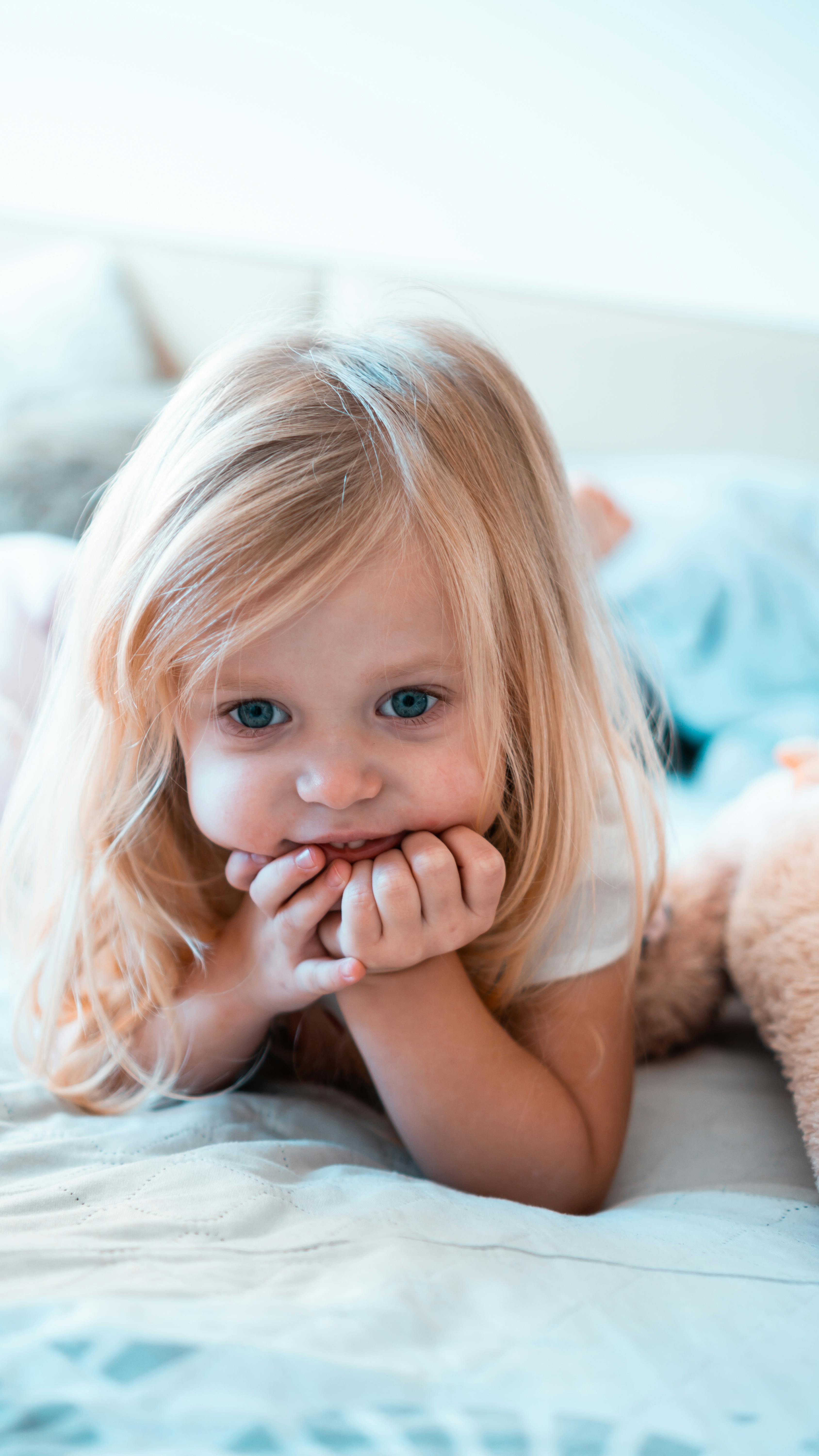 A Young Girl with Blonde Hair and Blue Eyes · Free Stock Photo