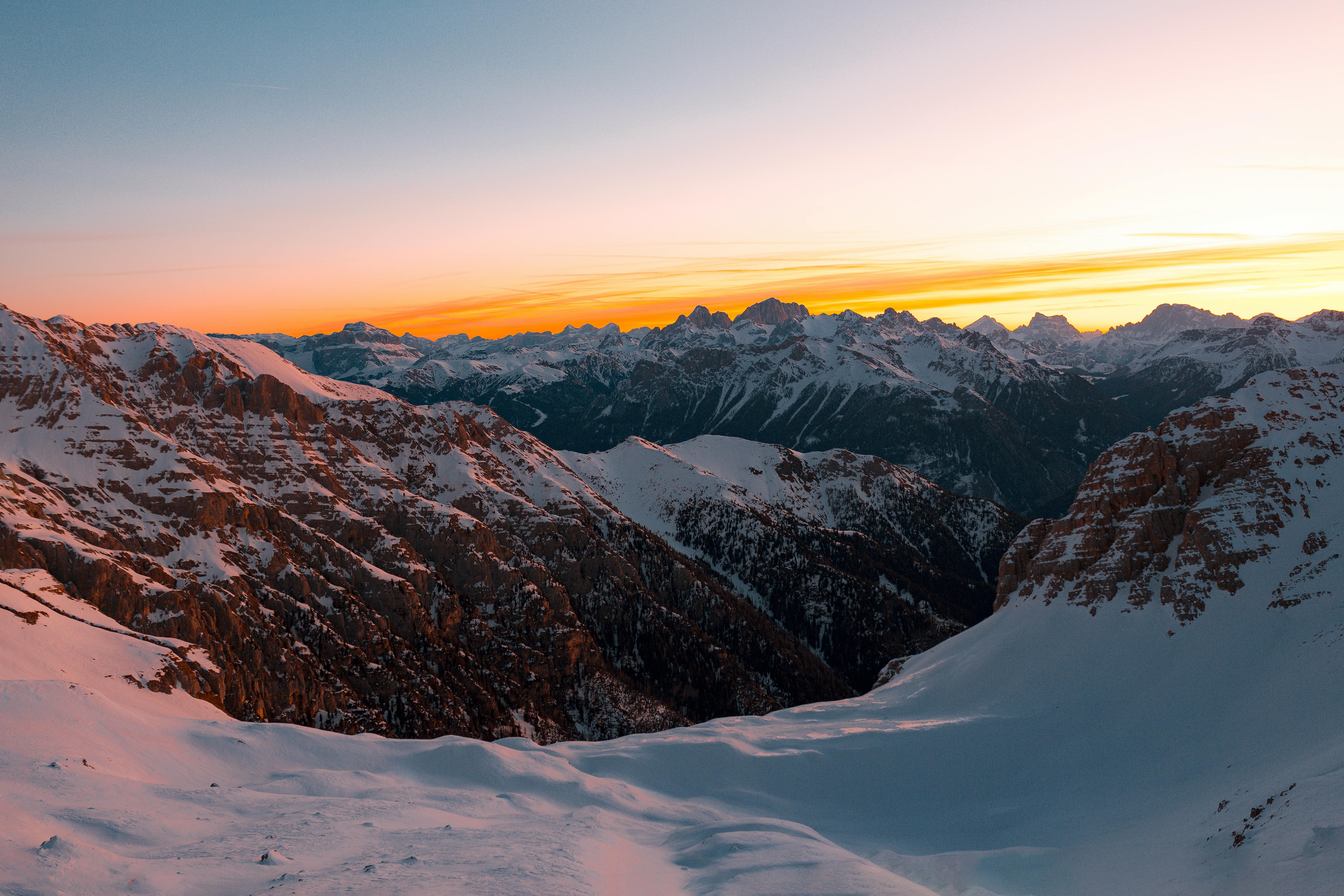 Prescription Goggle Inserts - A stunning view of snow-covered mountains at sunrise, showcasing nature's beauty.