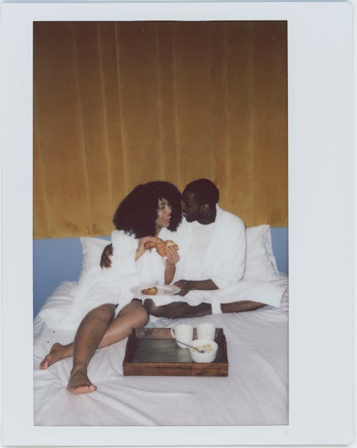 Free Couple Wearing Bathrobes Having Breakfast in Bed Stock Photo
