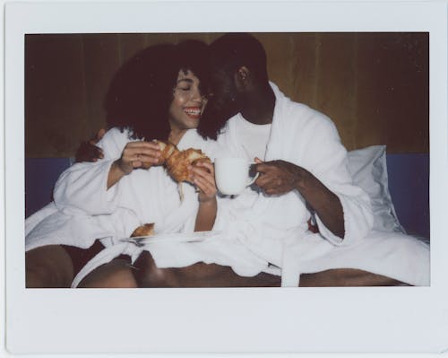 Free Couple Having Breakfast in Bed Stock Photo