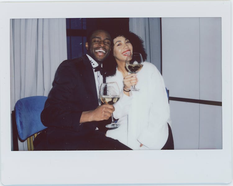 Man And Woman Sitting On Chair Drinking Wine