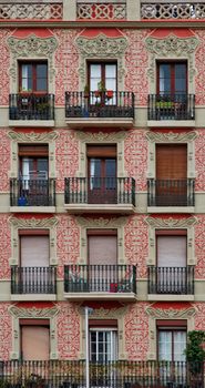Colorful residential building with decorative balconies in Barcelona, Spain.