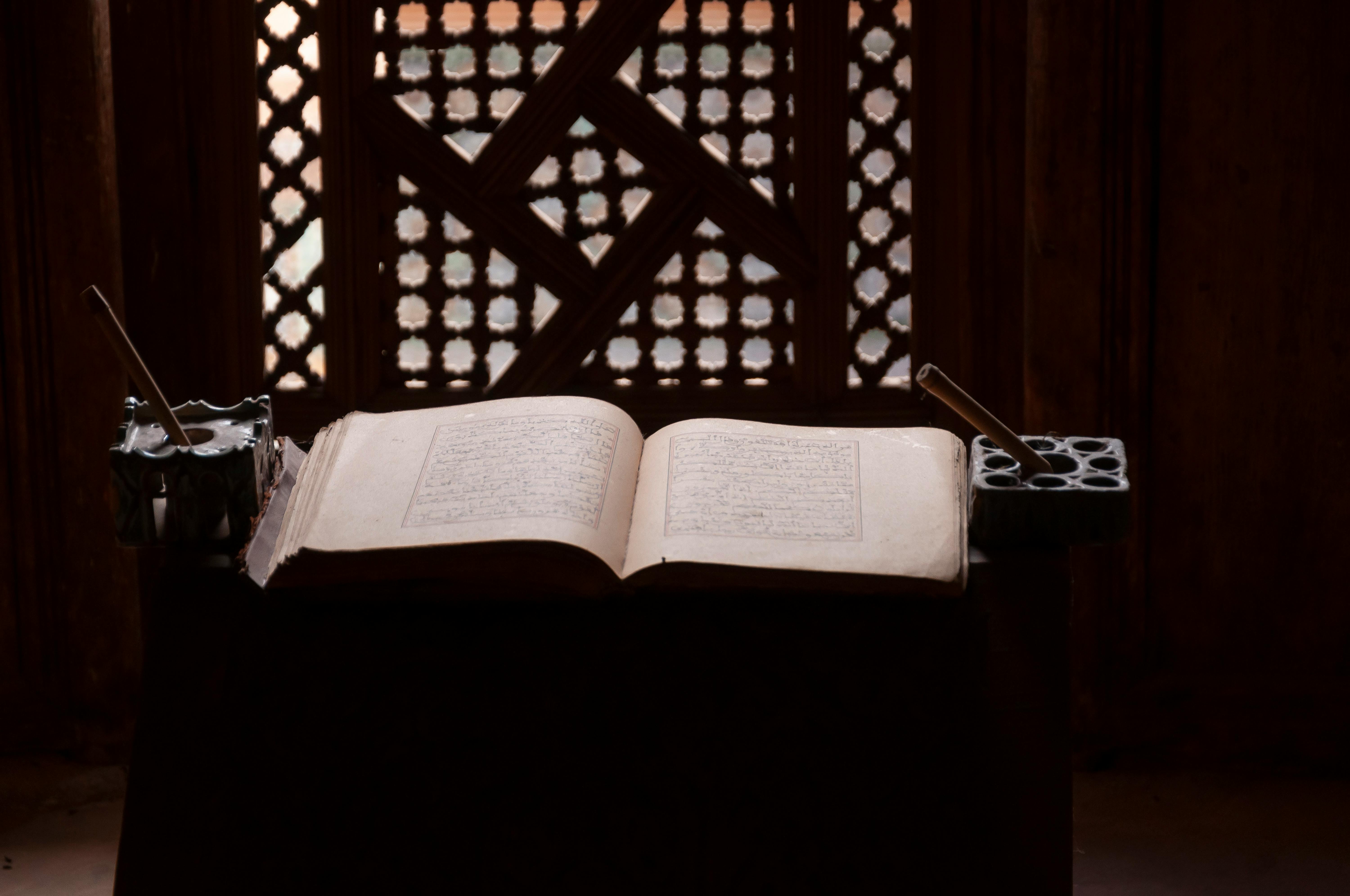 opened koran placed on table in traditional islamic college