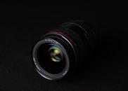 Modern photo camera lens placed on table in dark studio