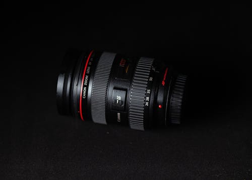 Lens of modern digital camera against black background