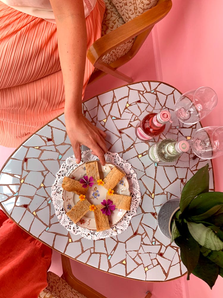 Woman Reaching For A Snack On A Coffee Table 