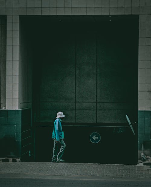 Person Walking on a Sidewalk in City