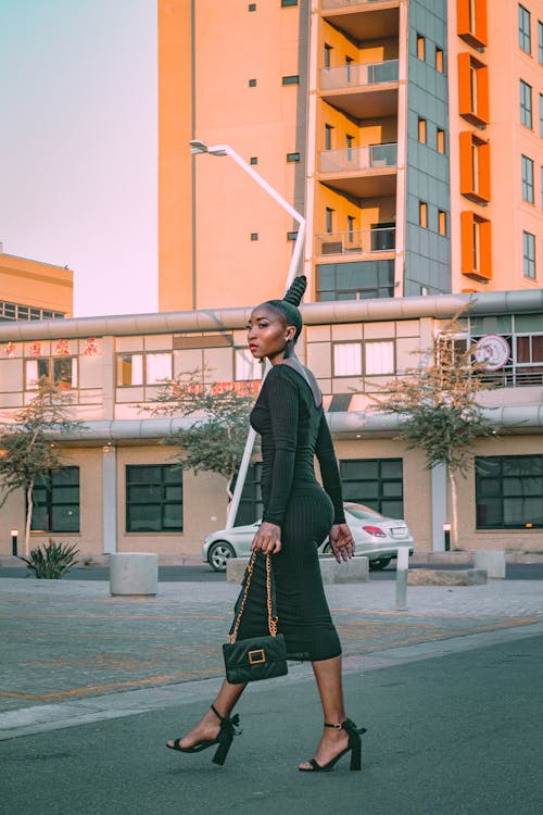 A Woman in a Stylish Outfit Walking in an Urban Area