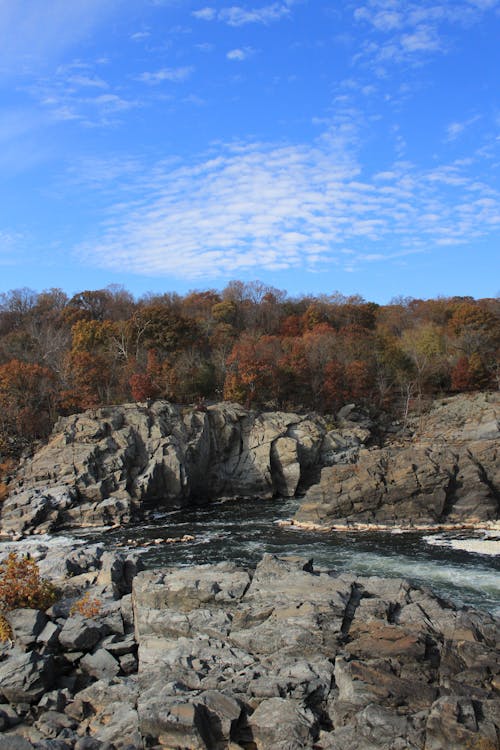 Free Drone Shot of a Body of Water between Natural Rock Formation Stock Photo