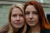 Women Posing Cheek to Cheek with Each Other