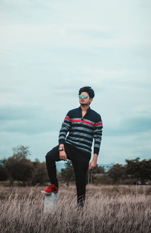 A Young Man in the Grass Field