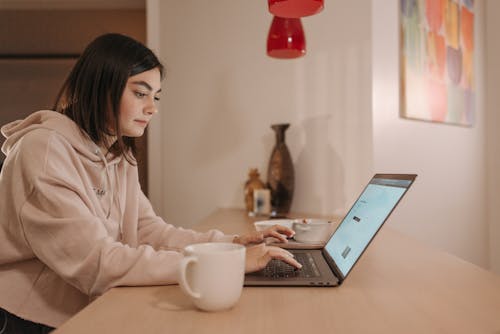 A Woman Using a Laptop while Working at Home