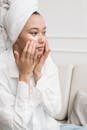 A Woman in a Head Towel using Under Eye Masks